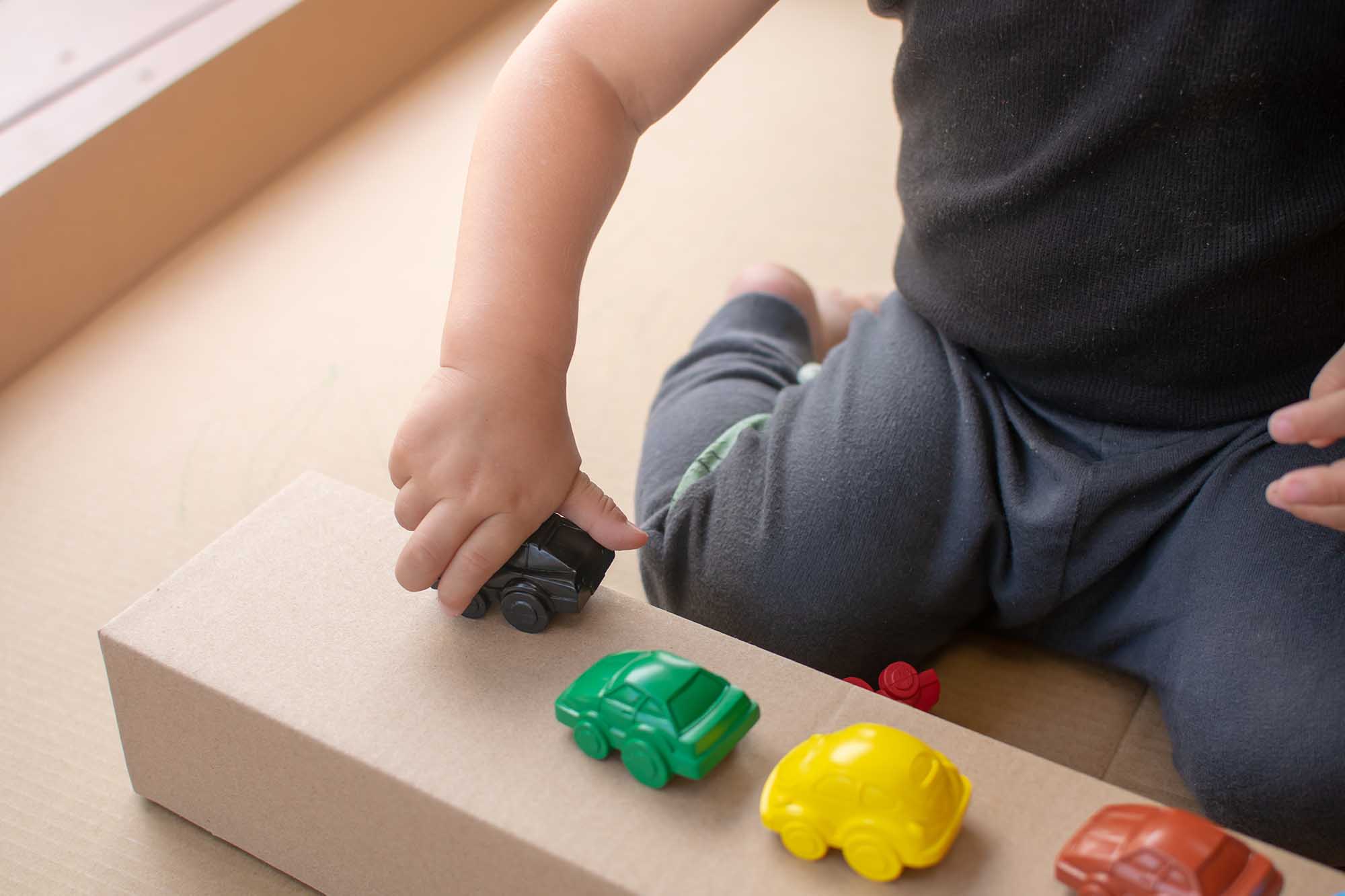 Child Playing With Toy Cars